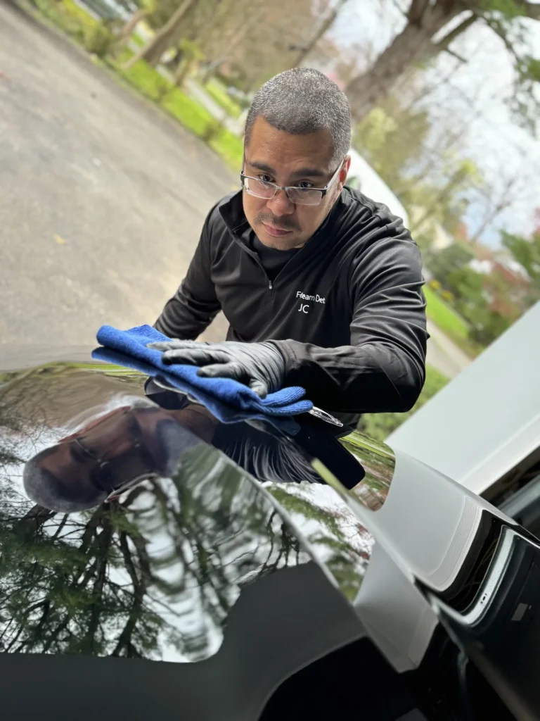 JC hand-drying a vehicle in a client's driveway