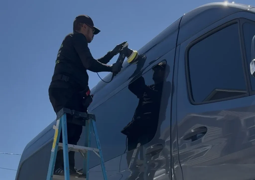 JC machine-polishing the upper panel of a Sprinter van